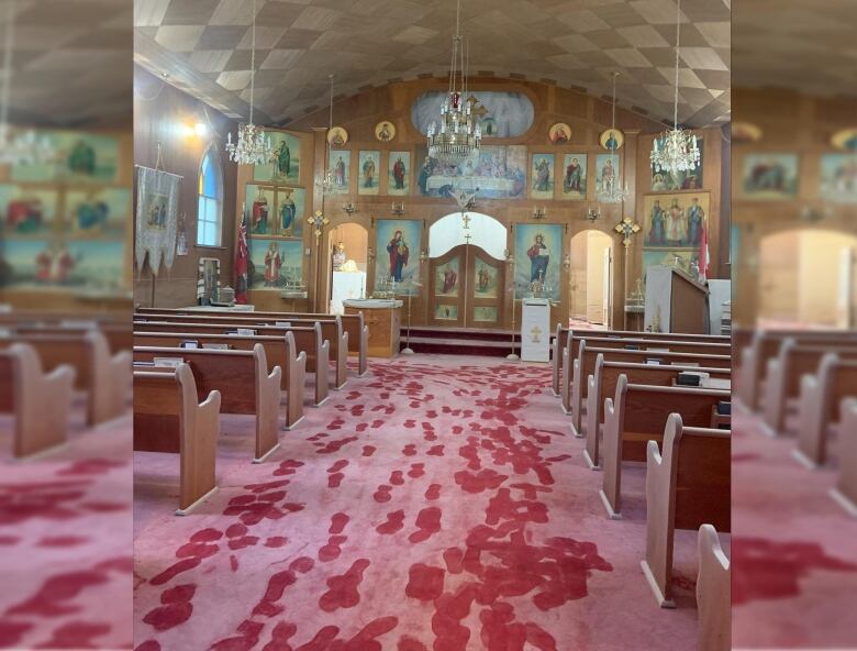 Footsteps are seen through a layer of white powder on a red carpet floor in a church. 