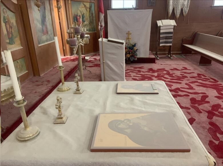 Footsteps are seen through a layer of white powder on a red carpet floor in a church that was vandalized. Pews, icons and more were covered. 