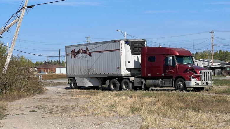 Tilted power pole by truck.