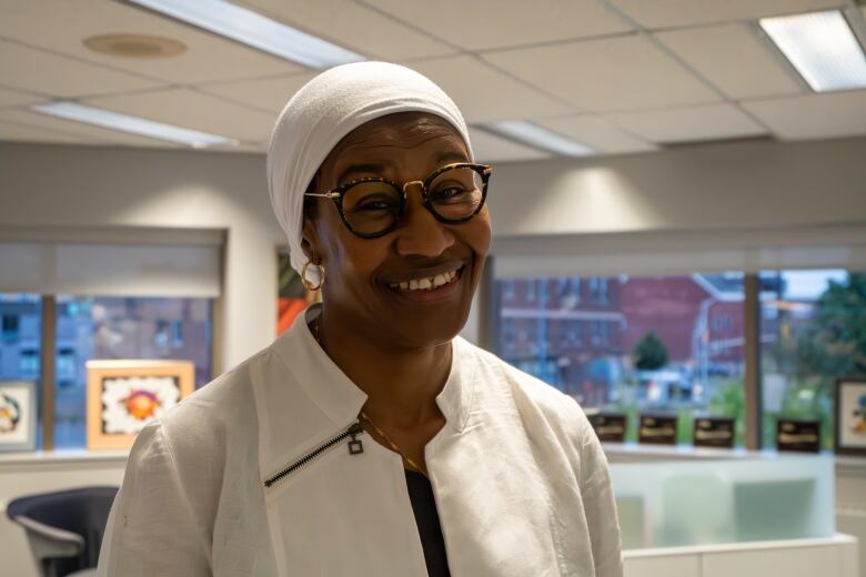 A woman smiles at the camera.