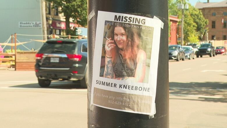 Missing person poster showing Summer Kneebone's face on telephone pole.