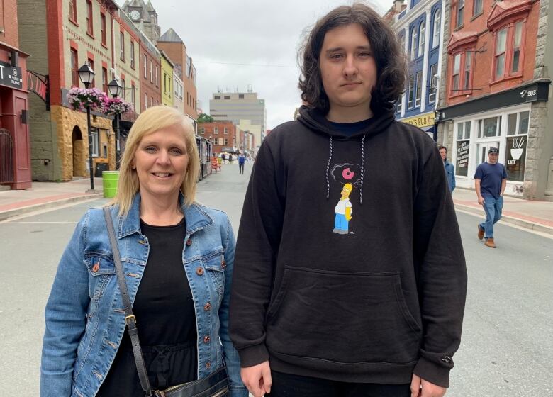 A man and a woman on the pedestrian mall in downtown St. John's. 