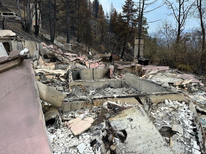 Charred remains of a home with debris visible.