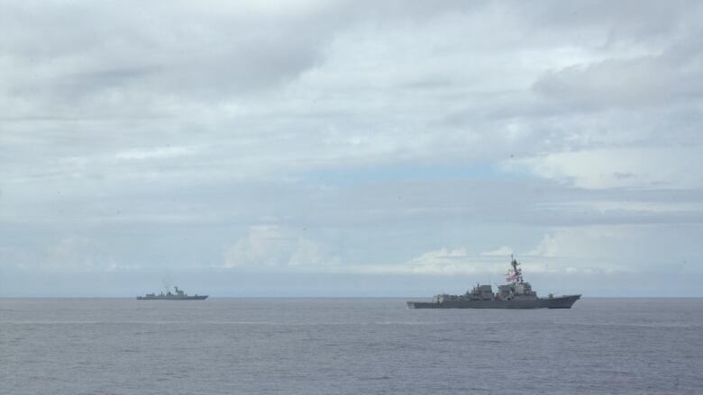 Chinas Luyang destroyer gives way to the USS Ralph Johnson, a US Navy vessel, as it pulls away from an anti-submarine exercise with allies.