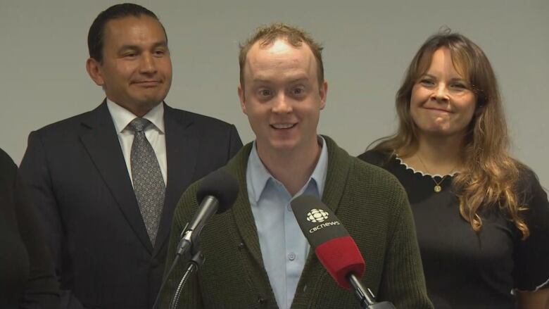 Two doctors and a politician at a campaign announcement. 