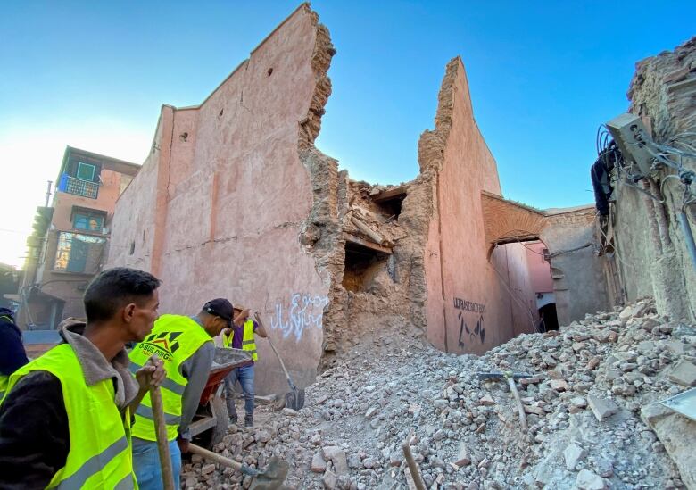 People work next to earthquake rubble in Makkrech.