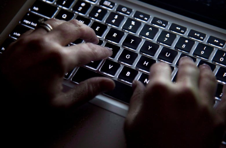 A person types on a keyboard.