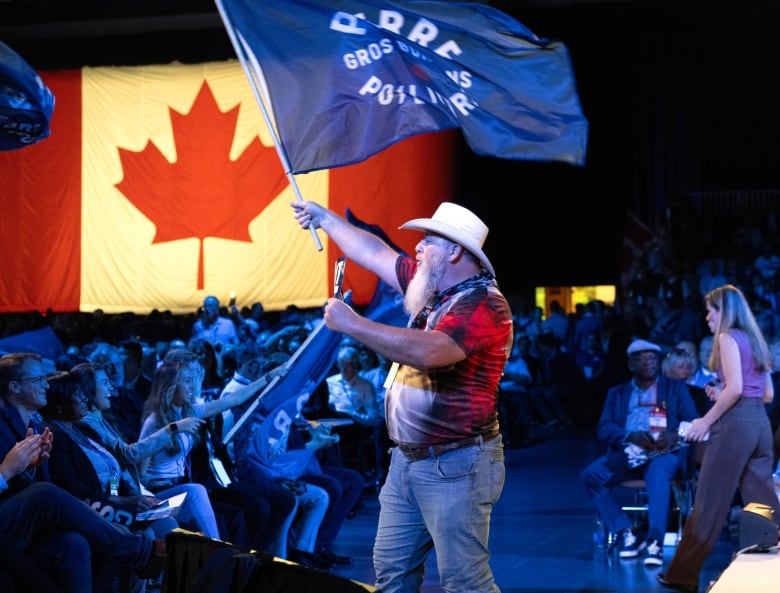 Conservative delegate Patrick Wuori waves a flag.