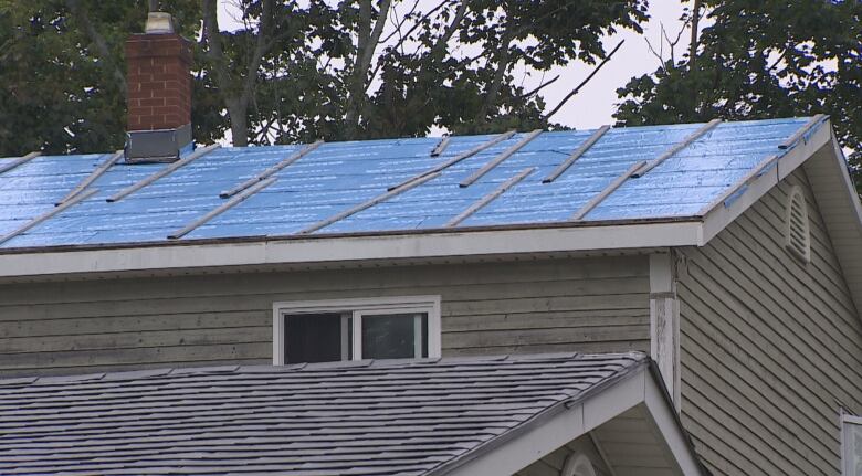 Roof covered with tarp.