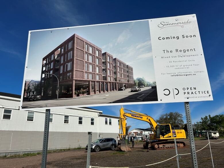 Sign advertising the building of the Regent in Summerside, with backhoe in the background.