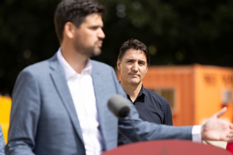 Prime Minister Justin Trudeau watches Minister of Housing Sean Fraser as he speaks at the construction site of an affordable housing project in London, Ont. on Wednesday, September 13, 2023.