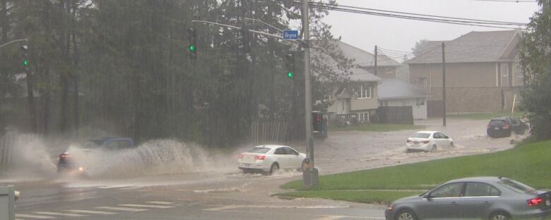 Vehicles driving on a road with deep water