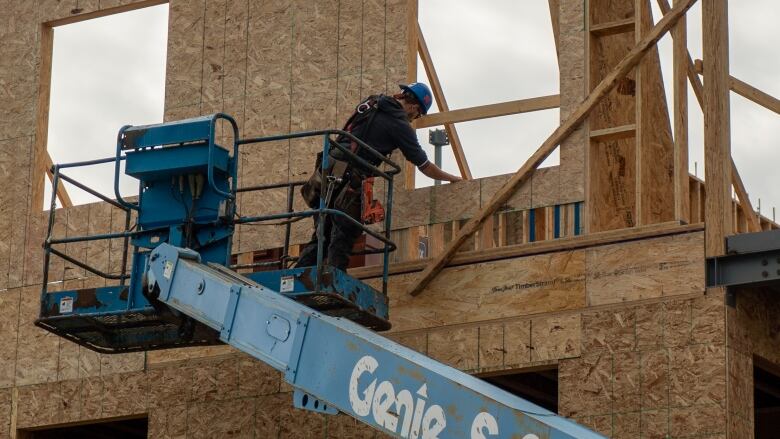 A construction worker builds a home. 