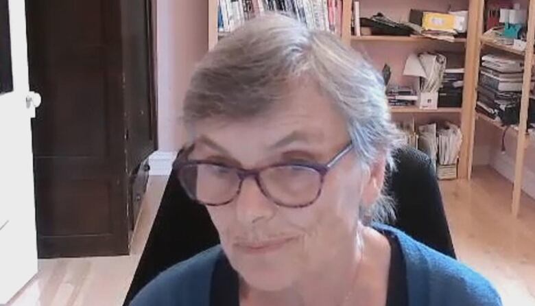 A Zoom screengrab showing a woman with glasses.