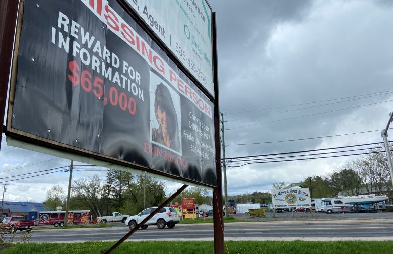 A billboard advertising a reward for information about Erin Brooks.