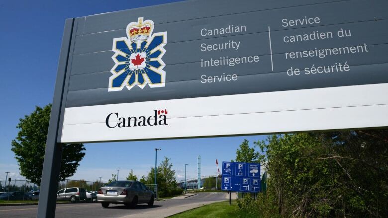 A grey and white sign reading Canadian Security Intelligence Service.