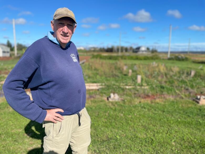 Jim Randall looks at the camera - his waterfront property behind him. 