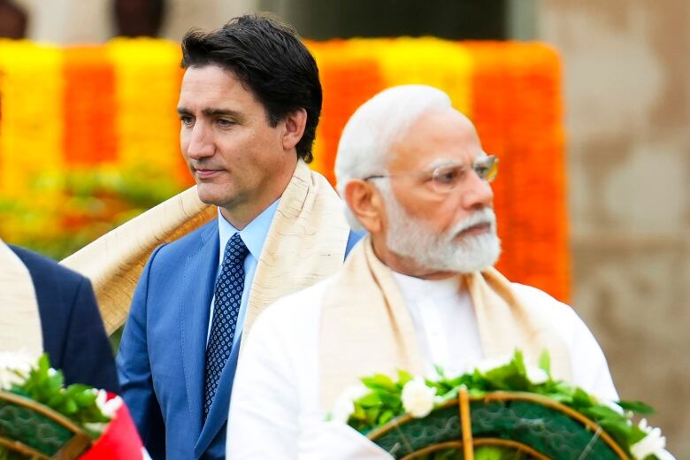 Canada's Prime Minister Justin Trudeau, left, walks past Indian Prime Minister Narendra Modi as they take part in a wreath-laying ceremony at Raj Ghat, Mahatma Gandhi's cremation site, during the G20 Summit in New Delhi on Sunday, Sept. 10, 2023. 