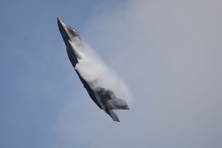 A fighter jet is shown in closeup in the sky.