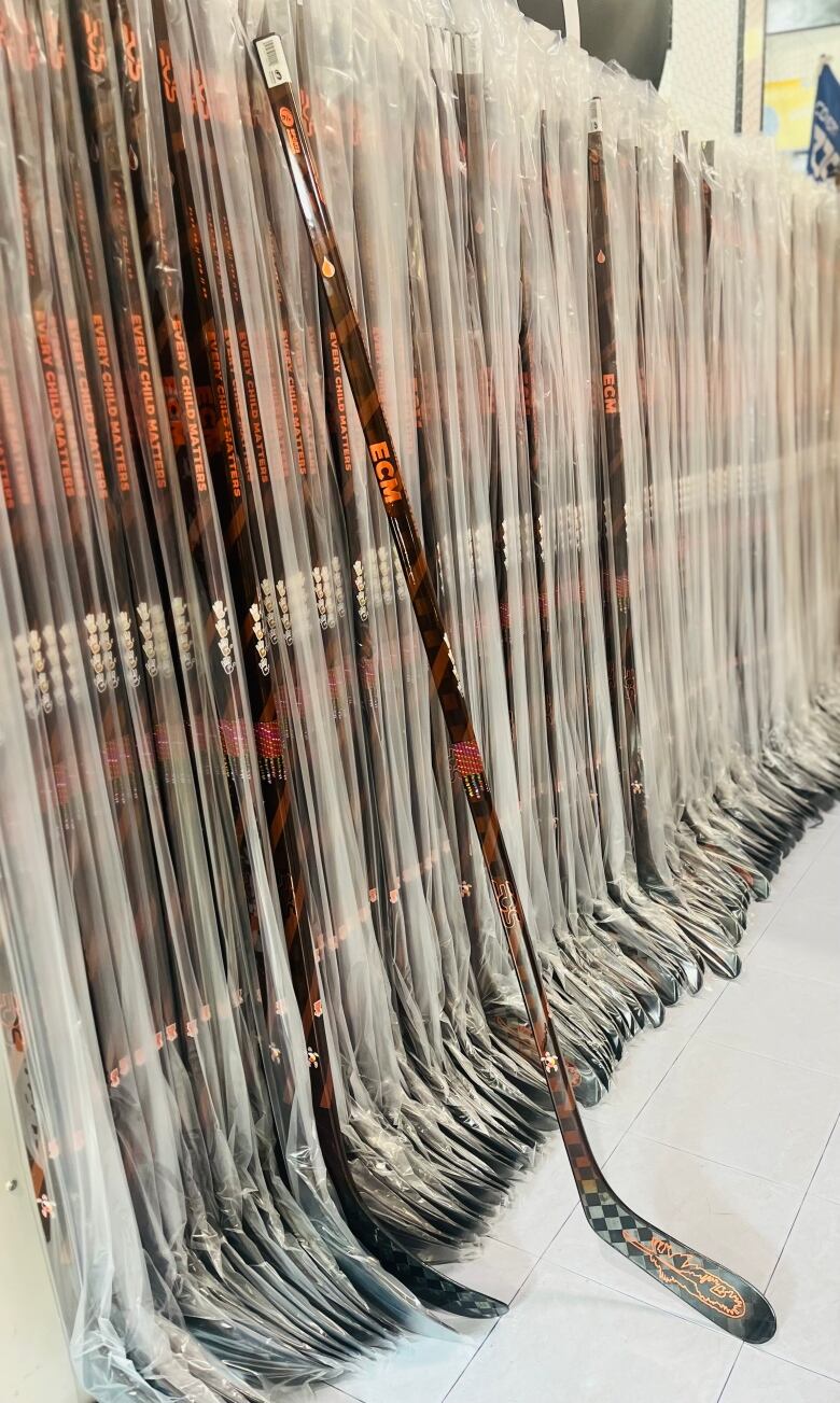 Line of the Every Child Matters Hockey Sticks at the Snipe and Celly sporting goods store on Flying Dust First Nation