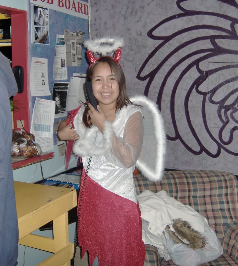 Angel Carlick in a photo from Halloween 2006, wearing a costume that combines devil and angel features (halo, horns, wings, etc.)