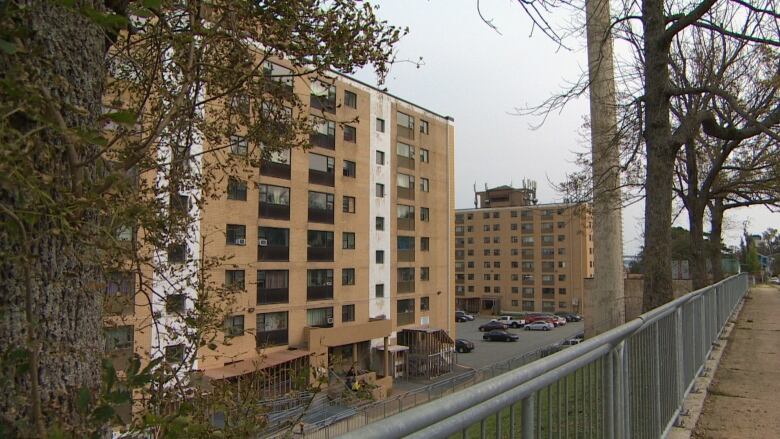 A beige and white mid-rise building is shown. 