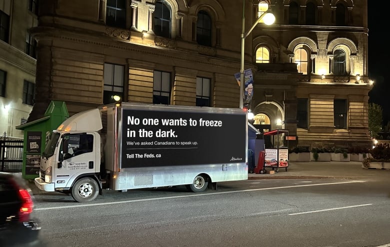 A truck is shown parked at night in from of the Parliament Buildings in Ottawa.