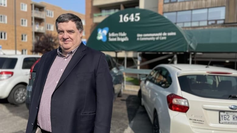 man in jacket standing in the Saint Brigid's Home parking lot