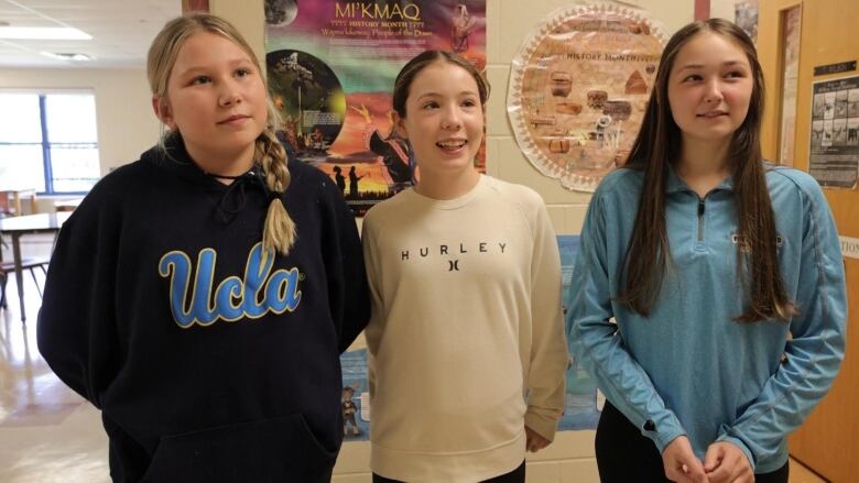 girls standing in a hall 