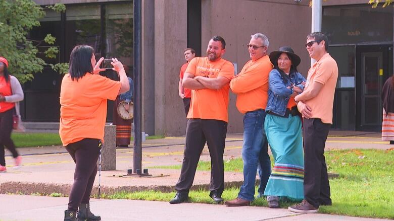 Abegweit First Nation Chief Junior Gould, second from left, poses for a photo during National Day for Truth and Reconciliation on Saturday.