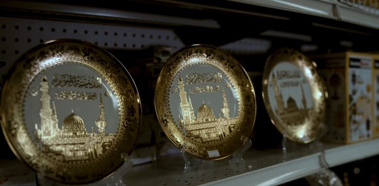 A row of gold plates on a shelf in a Desi store in Regina.