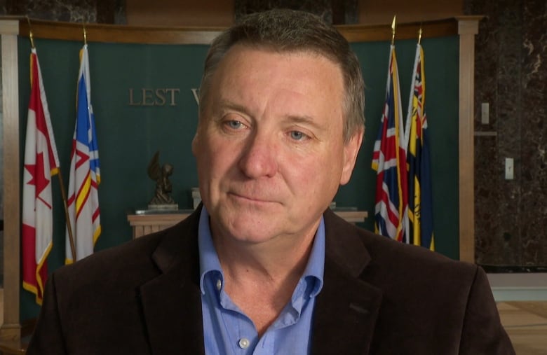 A man stands in the lobby of confederation building