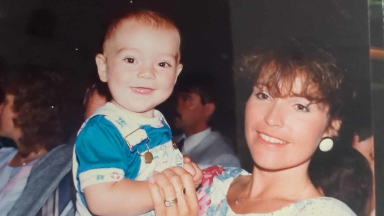 A mother holds a smiling baby