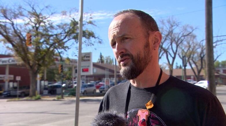 A man in a black t shirt.