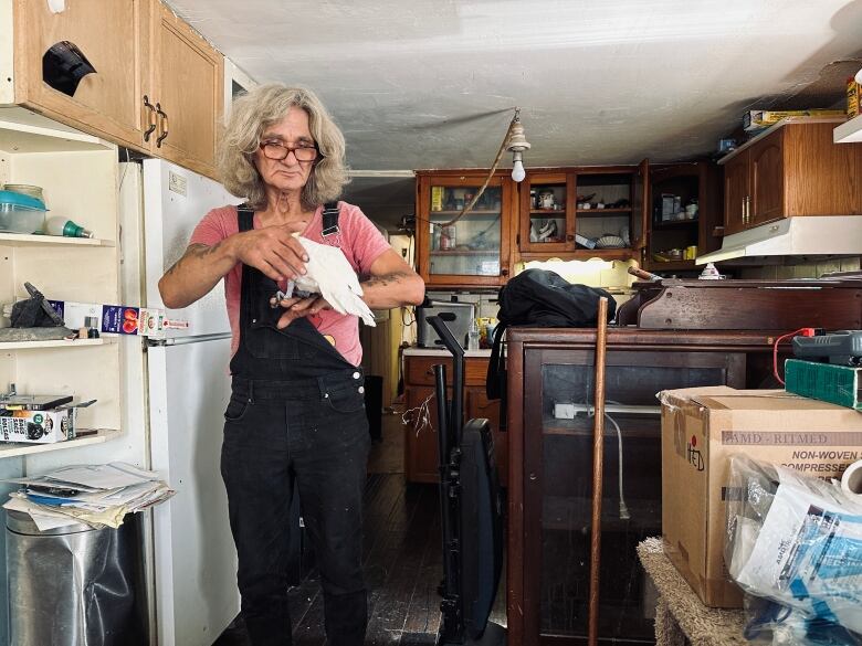 Hedden with his parrot inside of his trailer at Maple Ridge RV Park. 