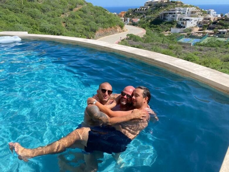 three men in pool