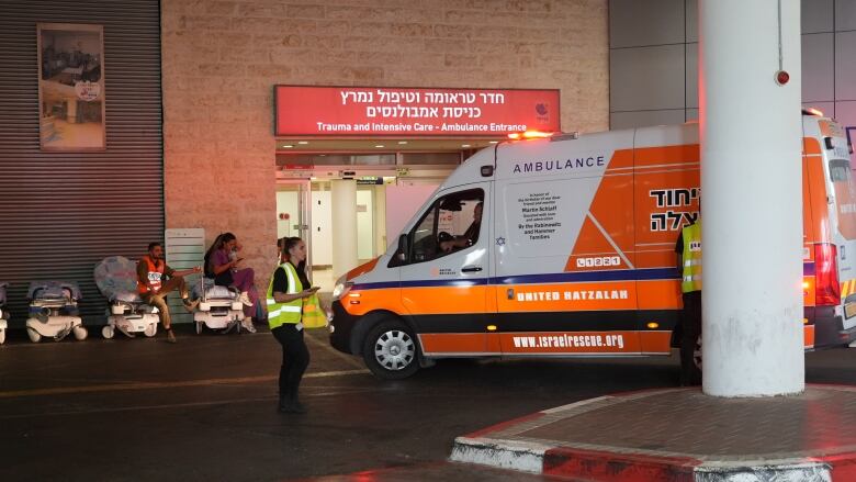 An ambulance pulls into a hospital emergency bay.