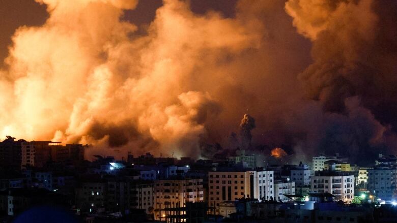 Flames and smoke billow during Israeli strikes in Gaza.