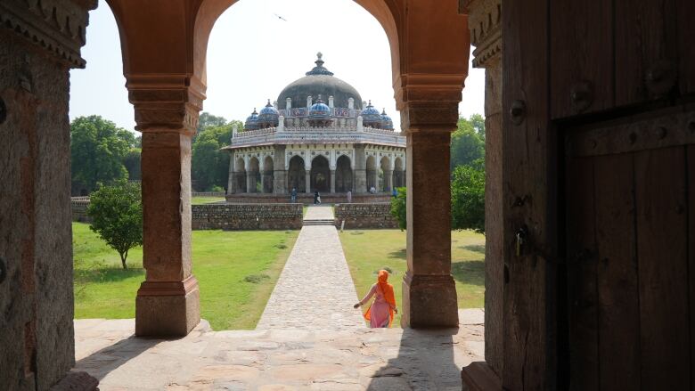 A woman walks towards the tomb of Mughal Emperor Humayun, a main tourist attraction in New Delhi, India. 