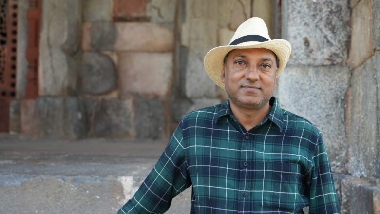 Delhi tour guide Yajur Chauhan stands in front of the 16th century tomb of Mughal Emperor Humayun. 