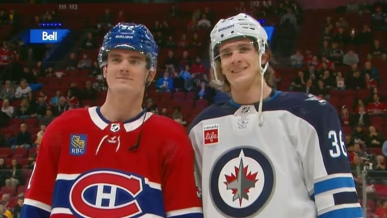 A hockey player in a red Montreal Canadiens jersey on the left and a hockey player in a white Winnipeg Jets jersey on the right.