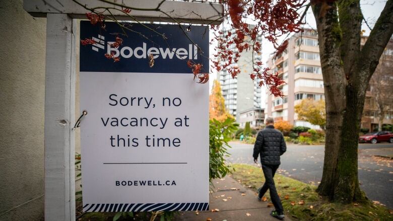 A rental availability sign showing no vacancy is pictured outside of an apartment building in B.C. on a fall day.