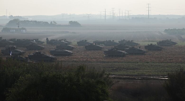 Israeli tanks and military vehicles gather near the edge of the Gaza Strip in southern Israel.