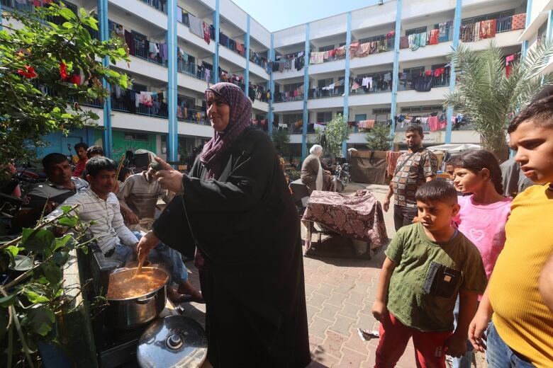 A woman cooks outside.