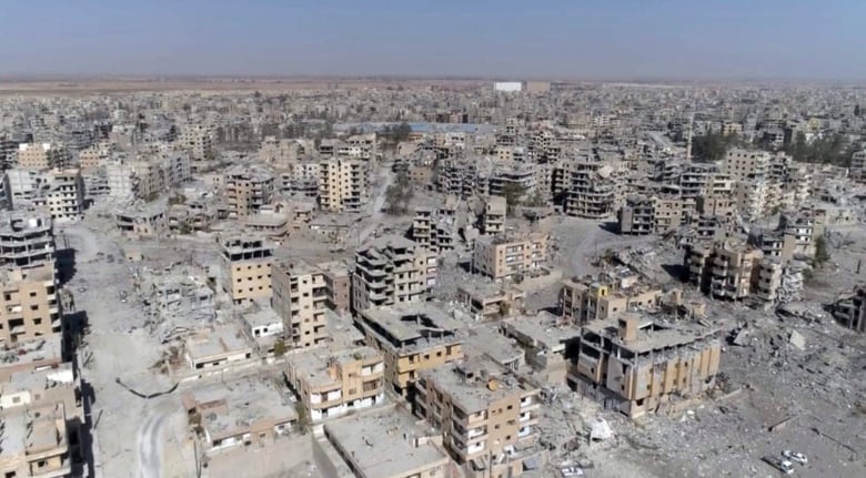 This Oct. 19, 2017, image from drone video, shows damaged buildings in Raqqa, Syria, two days after Syrian Democratic Forces said military operations to oust the Islamic State group ended. A U.S. military official says that the American-backed Syrian Democratic Forces in January 2018 captured two notorious British members of an Islamic State insurgent cell commonly dubbed The Beatles and known for beheading hostages.