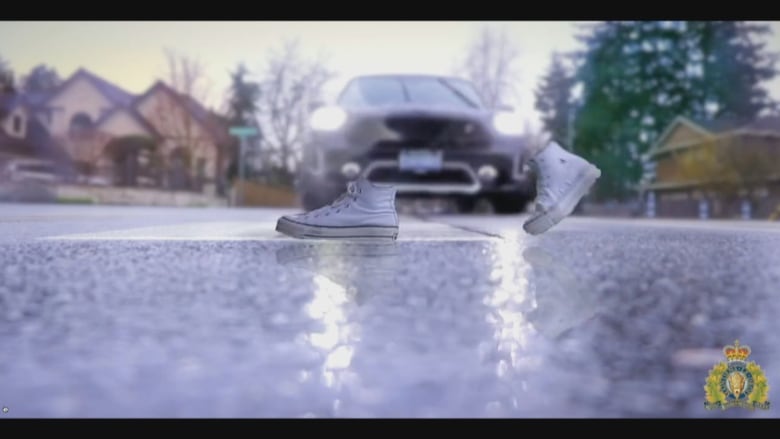 A car stops at a crosswalk where disembodied shoes of an 