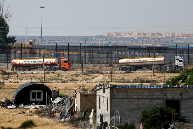 Two fuel trucks move towards the Egypt-Gaza border crossing, in Rafah, Gaza.