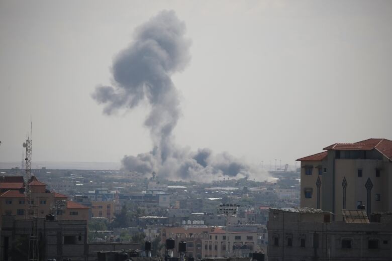 Smoke rises from an area in Rafah hit by an Israeli strike in southern Gaza Strip.