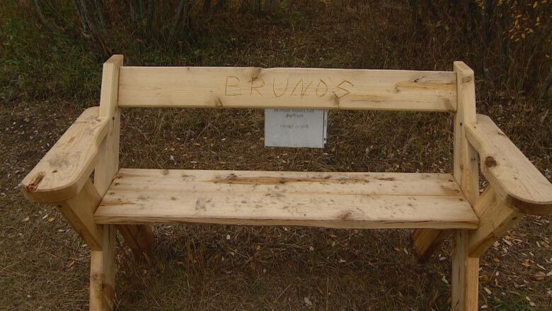 A bench with engravings is pictured.