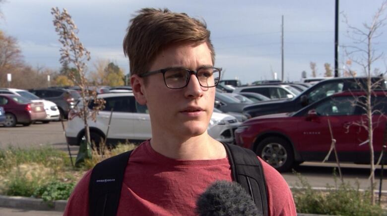 A young man in a red tee.